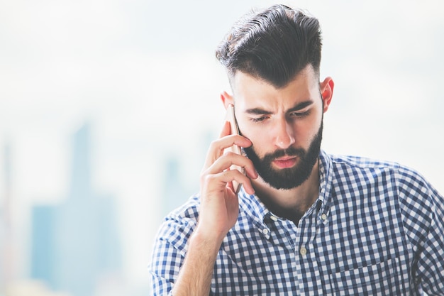 Homem pensativo no telefone