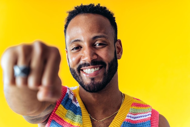 Homem posando em fundos coloridos no estúdio vestindo roupas da moda