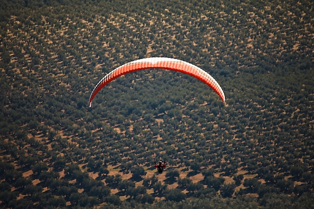 Homem praticando esporte radical de parapente