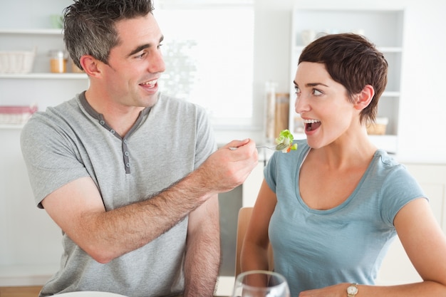 Homem que alimenta sua esposa fofa