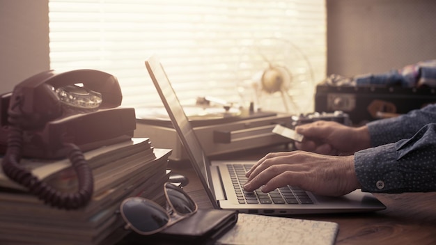 Foto homem reservando férias online com cartão de crédito