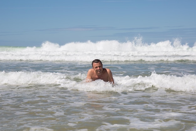 Homem se divertindo na praia durante o verão