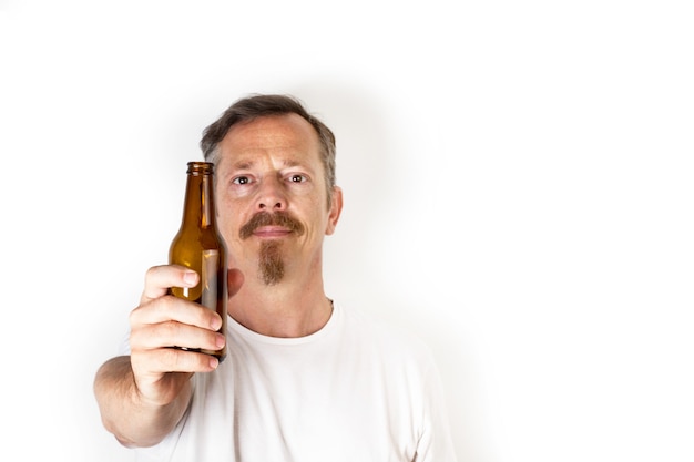 Foto homem segurando uma garrafa de cerveja na frente da boca em branco