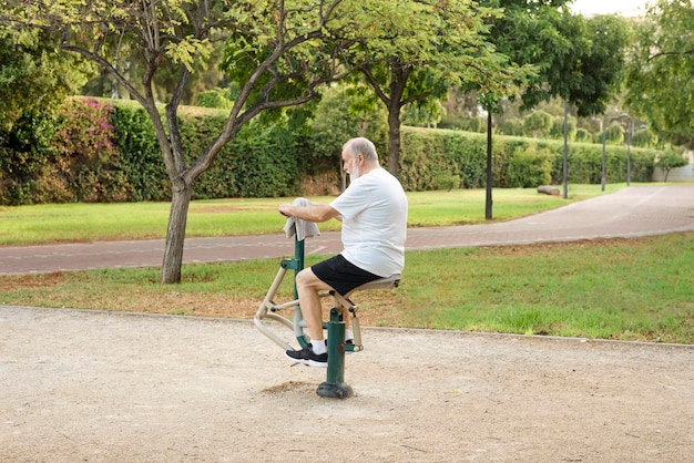 Homem sênior se exercitando na academia ao ar livre nos estilos de vida esportivos do parque e conceito de emagrecimento