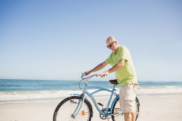 Homem senior sorridente com bicicleta