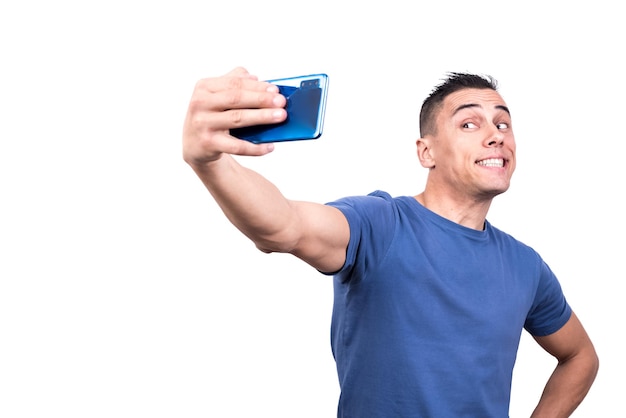 Homem sorridente tirando uma selfie com seu celular