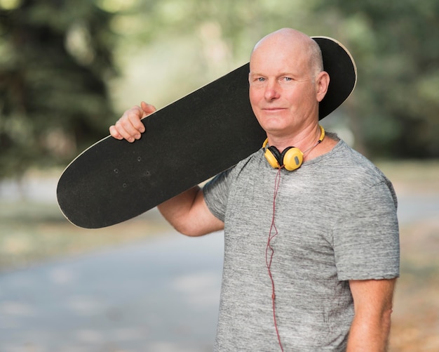 Foto homem tiro médio segurando um skate