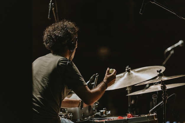 Homem tocando bateria em um concerto de música