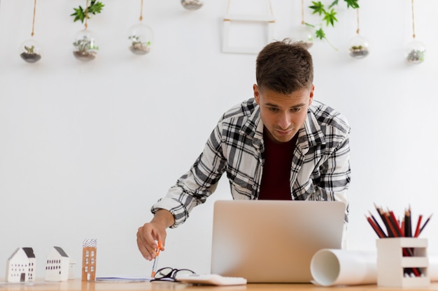 Homem trabalhando em casa no quarto branco moderno