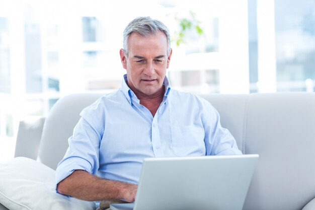 Homem trabalhando no laptop em casa