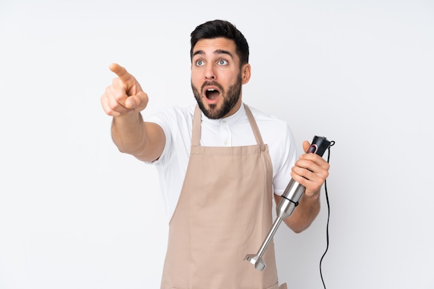 Homem usando o liquidificador em branco apontando para fora