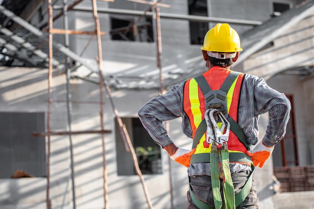 Homens asiáticos usando roupas de segurança Capacetes de operário e coletes reflexivos em canteiros de obras