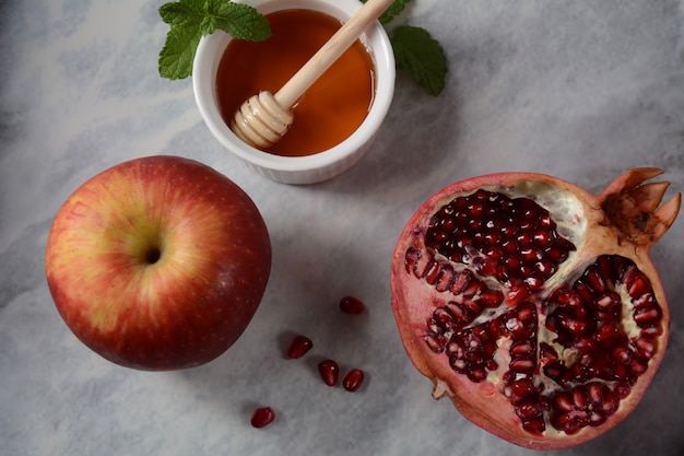 Honigglas, Granatapfel, frischer Apfel. Rosh Hashanah (jüdischer Neujahrsfeiertag) Konzept.