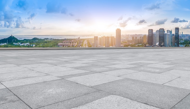 Horizonte panorámico y baldosas cuadradas vacías con edificios modernos