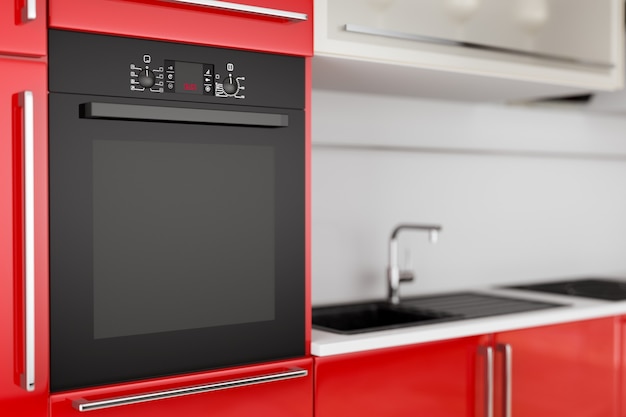 Horno eléctrico negro moderno construido en muebles de cocina rojos extreme closeup. Representación 3D
