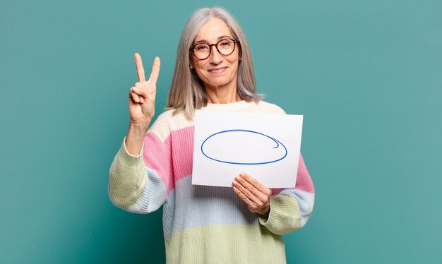 Hübsche Frau des grauen Haares mit einem leeren Kopienraum