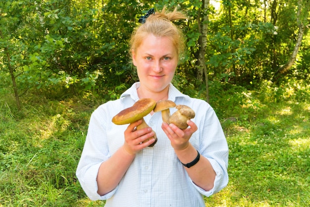 Hübsche Frau mit Pilzen in den Händen