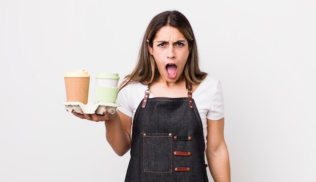 Hübsche hispanische Frau, die aggressiv schreit und sehr wütend aussieht, Kaffee zum Mitnehmen