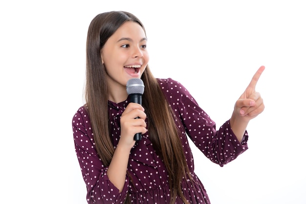 Hübsches kleines Mädchen, das mit dem Mikrofon singt Porträt eines emotional erstaunten, aufgeregten Teenager-Mädchens