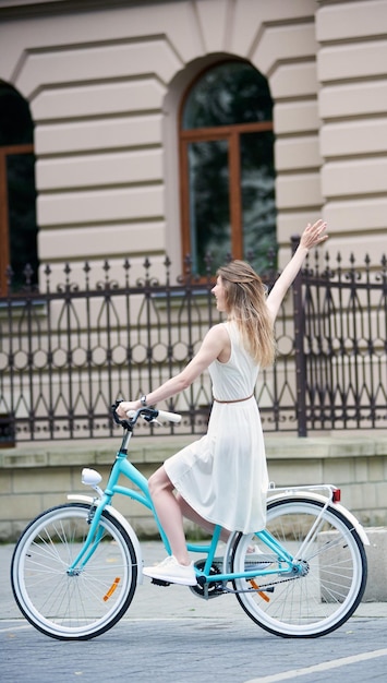 Hübsches Mädchen mit einem blauen Fahrrad