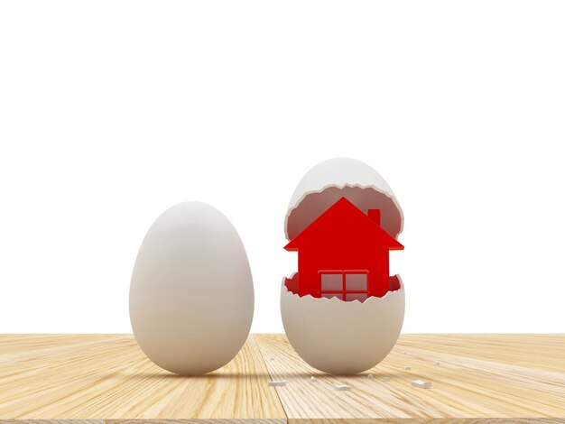 Un huevo entero y cáscara de huevo rota con casa.