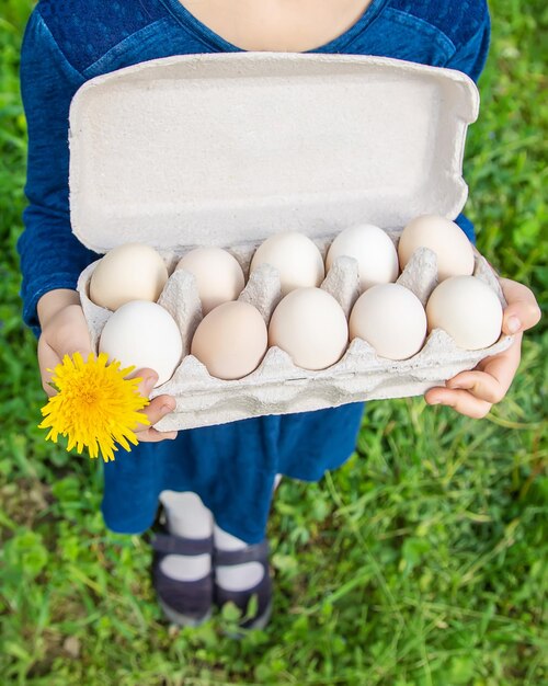 Huevos caseros en manos de un niño Enfoque selectivo