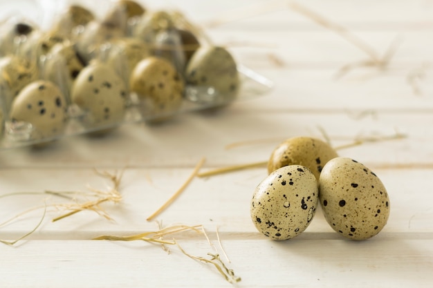 Huevos de codorniz en tablas de madera blancas.