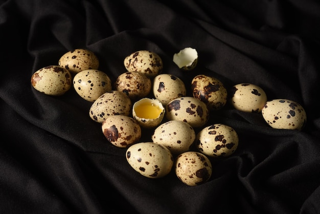 Huevos de codorniz en un trozo de tela negra Primer plano