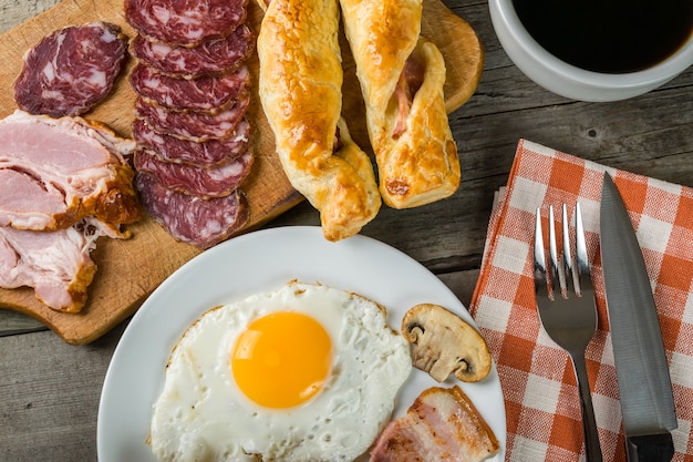 Huevos fritos, tocino y tostadas, delicioso desayuno.