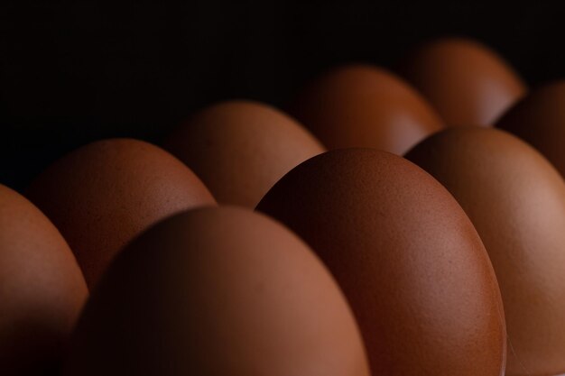 Huevos de gallina en una canasta de mimbre y en una toalla