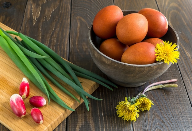 Huevos de Pascua y cebollas con rábano sobre una mesa