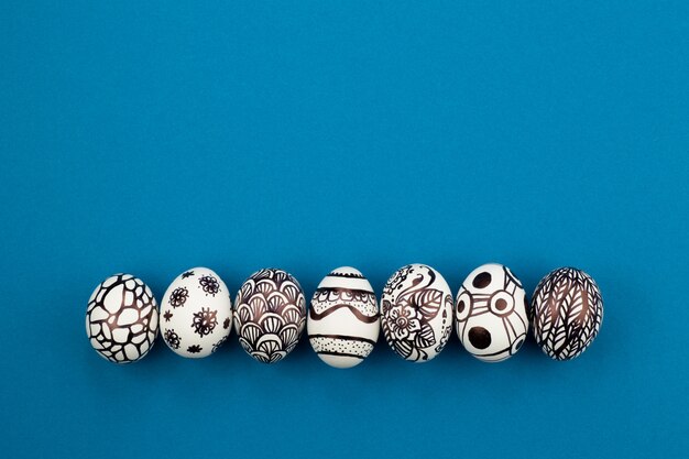 Los huevos de Pascua están pintados en blanco y negro, abstracción, dispuestos en una fila.