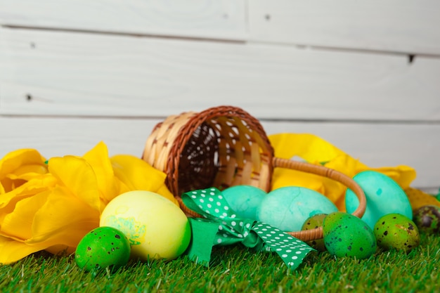 Huevos de Pascua con flores sobre hierba verde