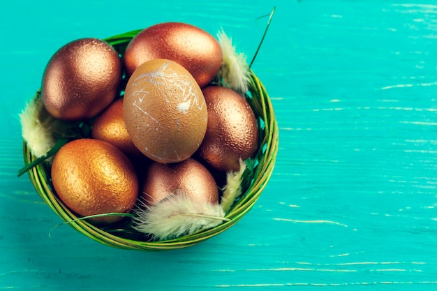 Huevos de Pascua oro en mesa de madera