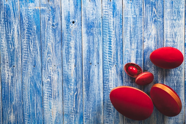 Huevos rojos sobre un fondo de madera azul