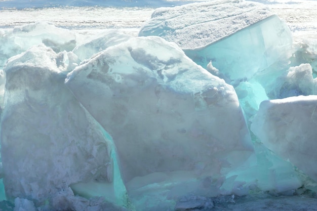 Hummocks transparentes claros de hielo azul en el lago congelado