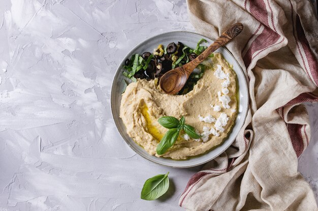 Foto hummus mit oliven und kräutern