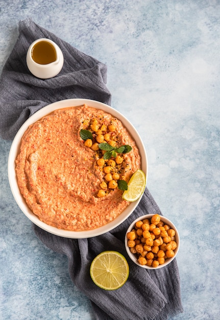 Hummus de pimiento rojo asado adornado con menta y lima