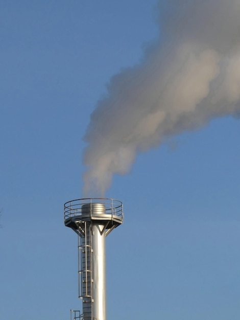 Foto el humo sale de una chimenea en una planta industrial