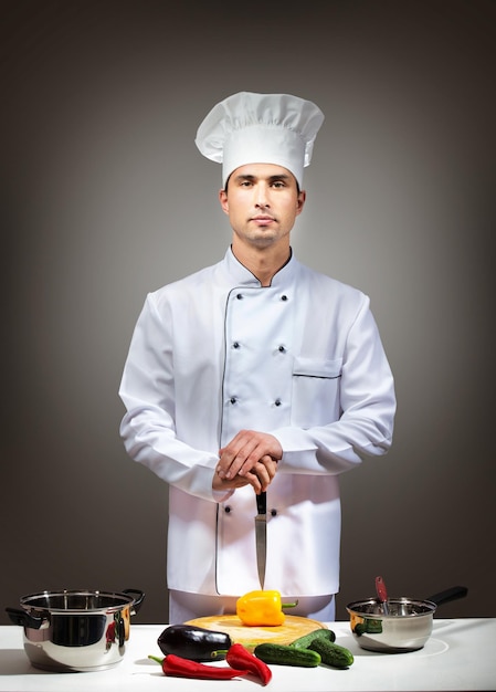 Humorvolles Porträt eines stolzen grauen Hintergrunds des Kochs