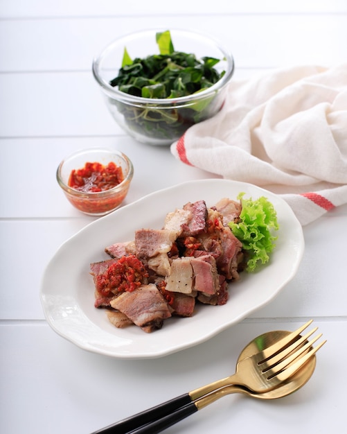 Se'i Sapi o Beef Sei es carne ahumada tradicional de Indonesia, servida con hojas de mandioca hervidas y Sambal Luat o Sambal Matah. Comida típica de Nusa Tenggara, Indonesia