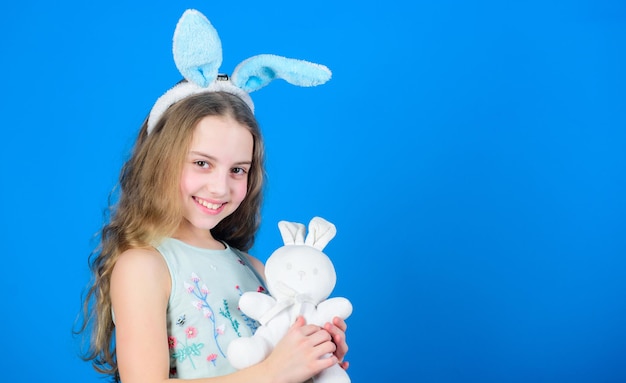 Ich liebe Ostern Kleines Kind im Ostern-Kaninchen-Stil spielt mit Spielzeug Kleines Kind mit niedlichen Spielzeug Osterhase Kaninchen Kleines Mädchen und Kaninchen-Spielzeug Kleines Baby in Hasenohren mit Ostern-Spielzeug-Kopie-Raum