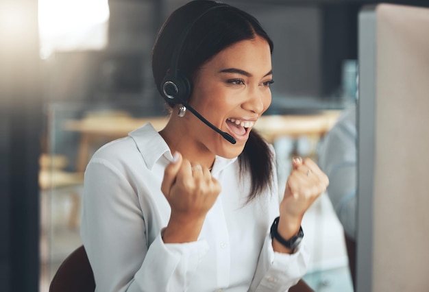 Ich wusste, dass ich dieses Problem lösen kann Aufnahme einer jungen Call-Center-Agentin, die allein in ihrem Büro sitzt und einen Erfolg feiert