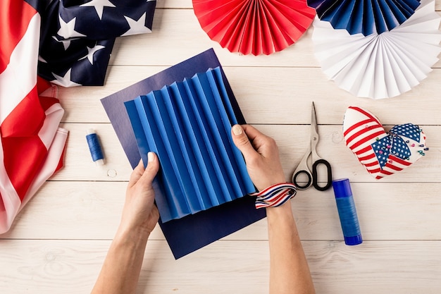 Idea de regalo, decoración 4 de julio, día de la independencia de Estados Unidos. Tutorial paso a paso manualidades de bricolaje. Haciendo abanicos de papel de colores, paso 2 - plegado de papel. Vista superior plana endecha