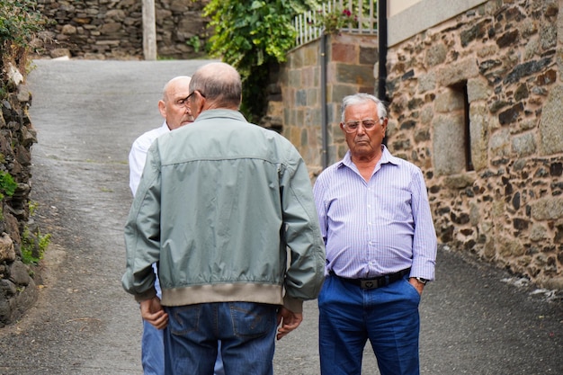 Idosos e aposentados conversando em uma rua em uma cidade