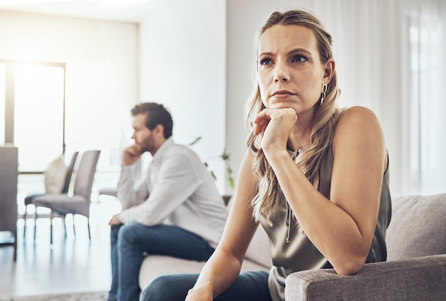 Ignorar enojado y pareja en el sofá en la lucha contra el divorcio o la depresión por el estrés del problema del matrimonio y la mujer triste que piensa con el fracaso de la pareja o la gente en la sala de estar con ira de conflicto y frustración