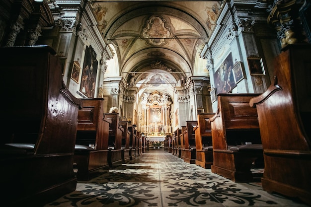 Igreja católica histórica Bancos de madeira seguidos e crucifixo da largura do altar