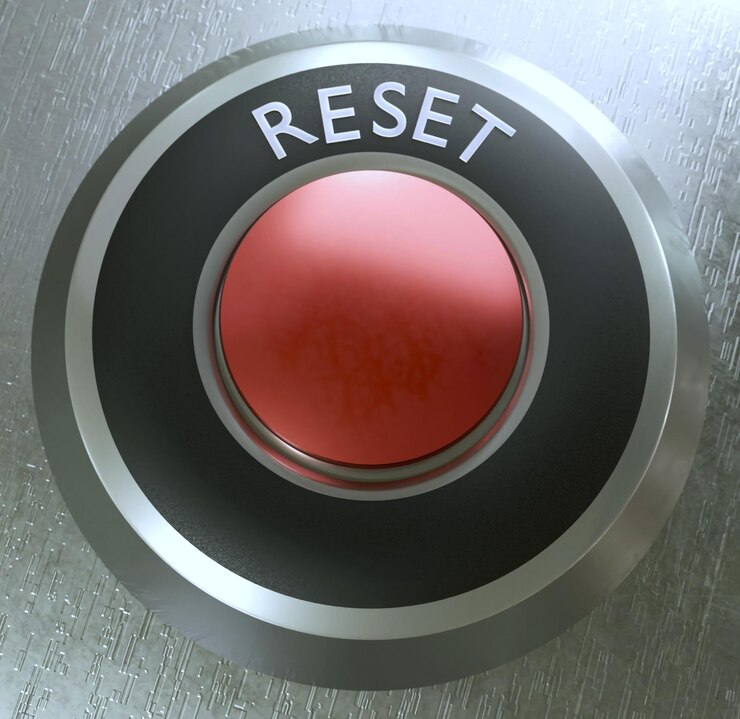 Foto ilustração 3d do botão de reset com núcleo vermelho na superfície de prata texturizada