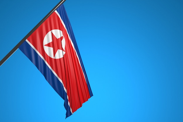 Ilustración de la bandera nacional de Corea del Norte en un asta de bandera de metal ondeando contra el cielo azul