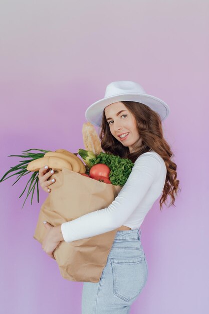 Im Supermarkt nutzt Frau Smartphone, lehnt sich an den Einkaufswagen.